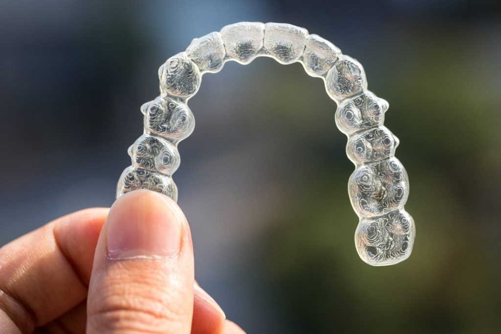 person holding clear braces