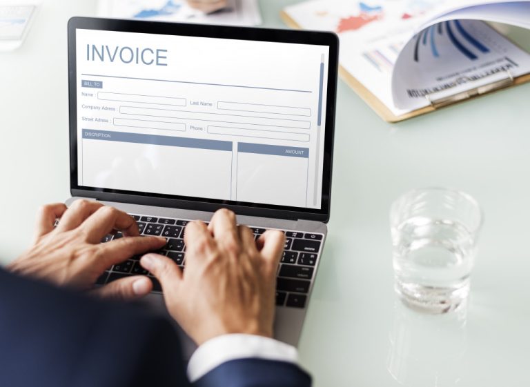 invoice word displayed on the laptop's screen